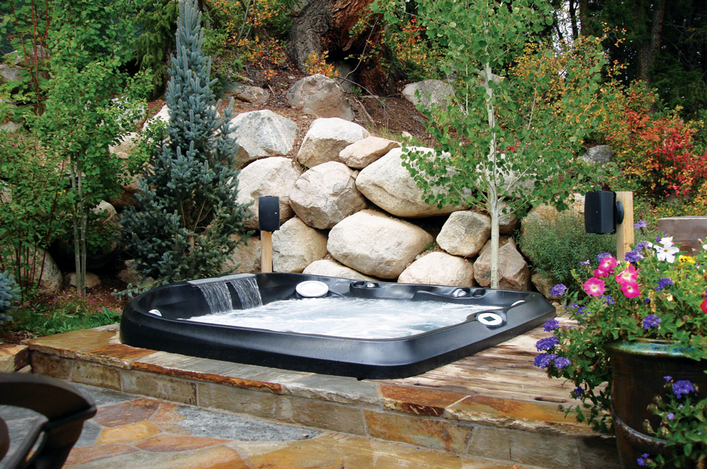 hot tub surrounded with landscaping - WCI pools and Spas