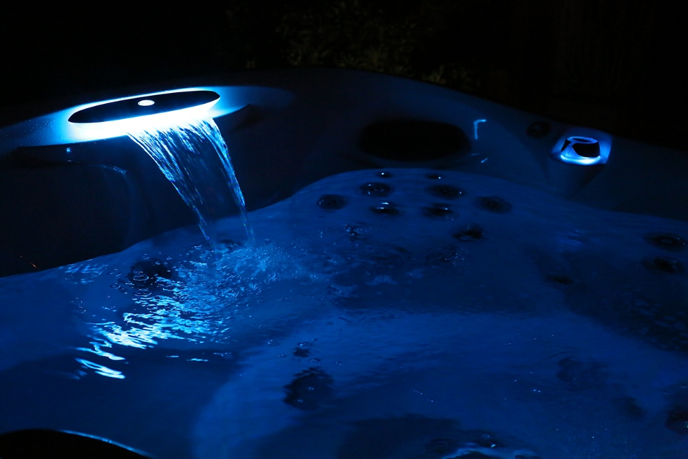 Jacuzzi® hot tub glowing blue in the night. - WCI Pools & Spas explains the 5 benefits of chromotherapy.
